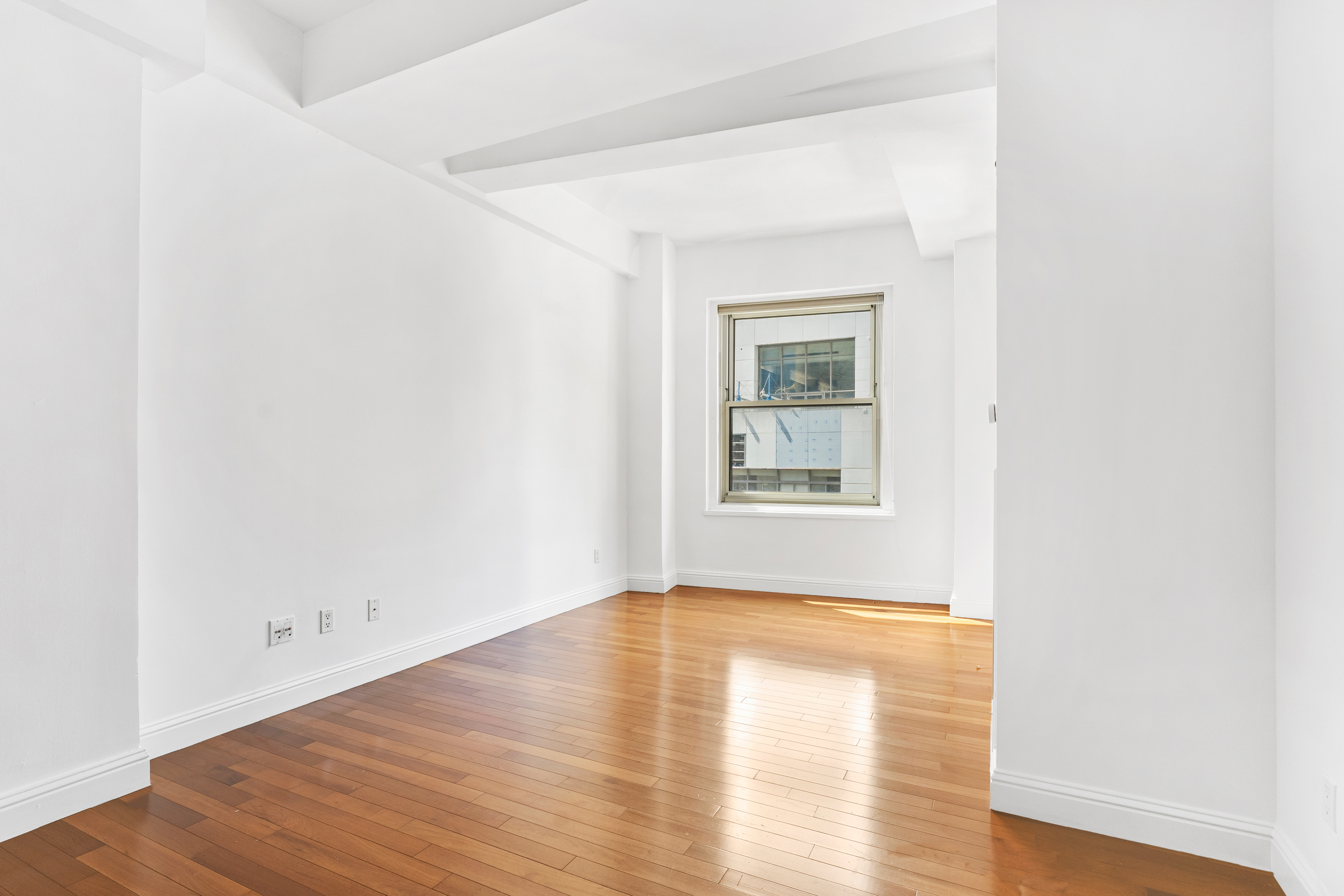 88 Greenwich Street, Unit 1212 Manhattan, NY 10006 - Photo 4 of 10 a view of empty room with wooden floor and fan