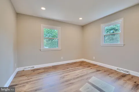 a view of a room with wooden floor and window