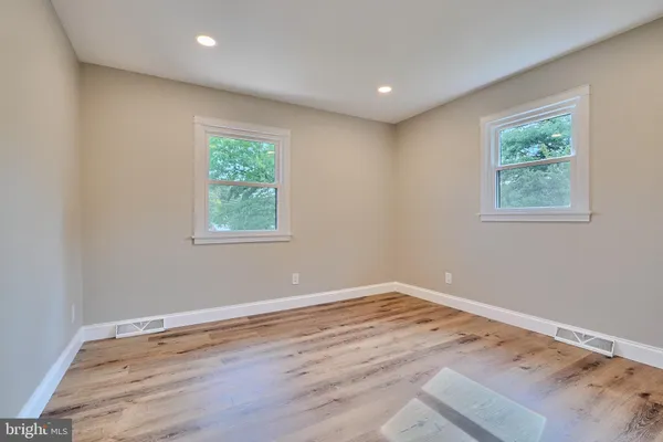 a view of a room with wooden floor and window