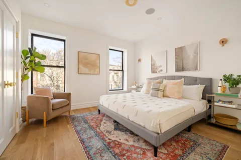 a bedroom with a bed and a couch