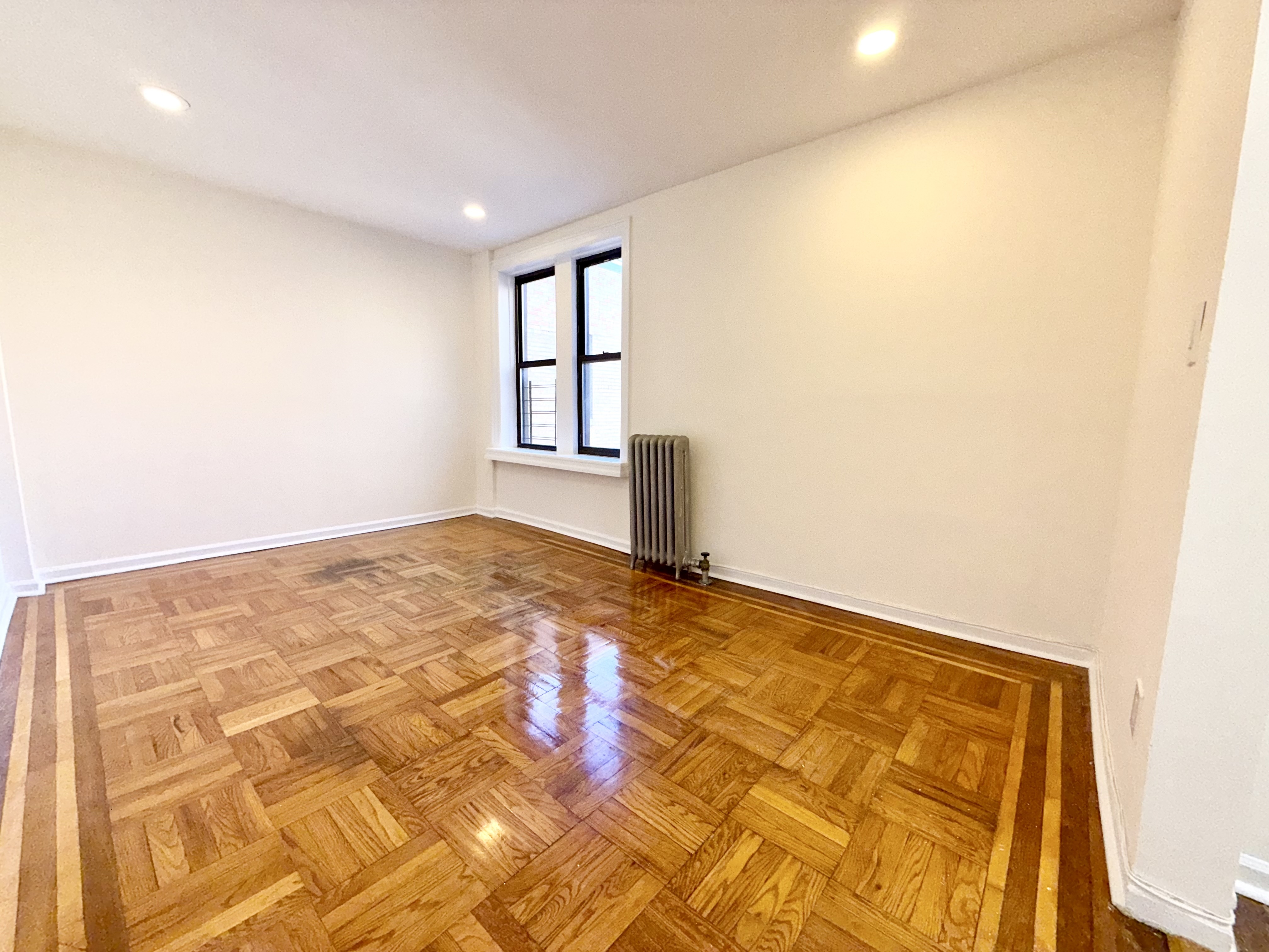 133 Seaman Avenue, Unit 3A Manhattan, NY 10034 - Photo 2 of 7 an empty room with windows