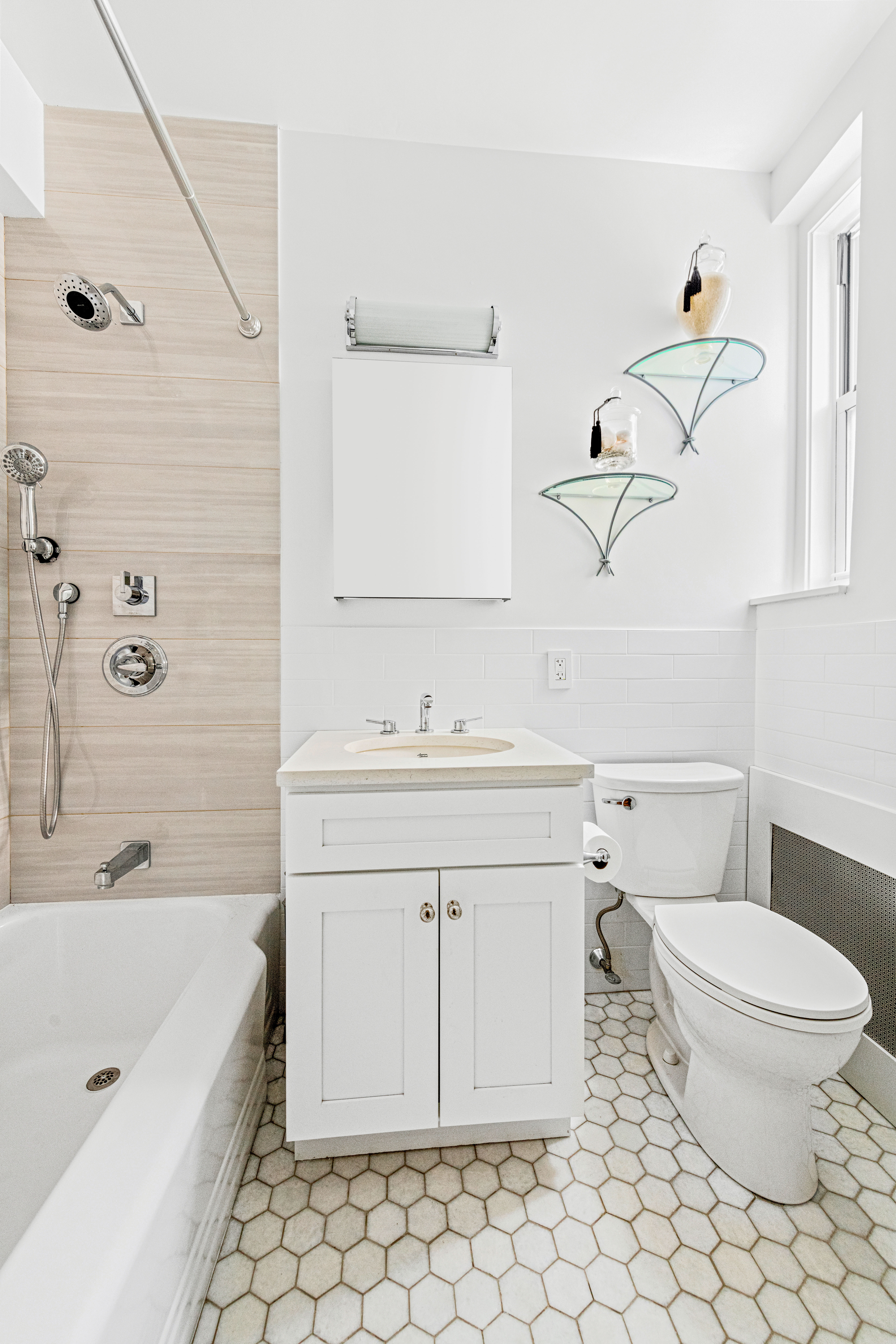 310 West 55th Street, Unit 5K Manhattan, NY 10019 - Photo 7 of 9 a bathroom with a sink a toilet and shower
