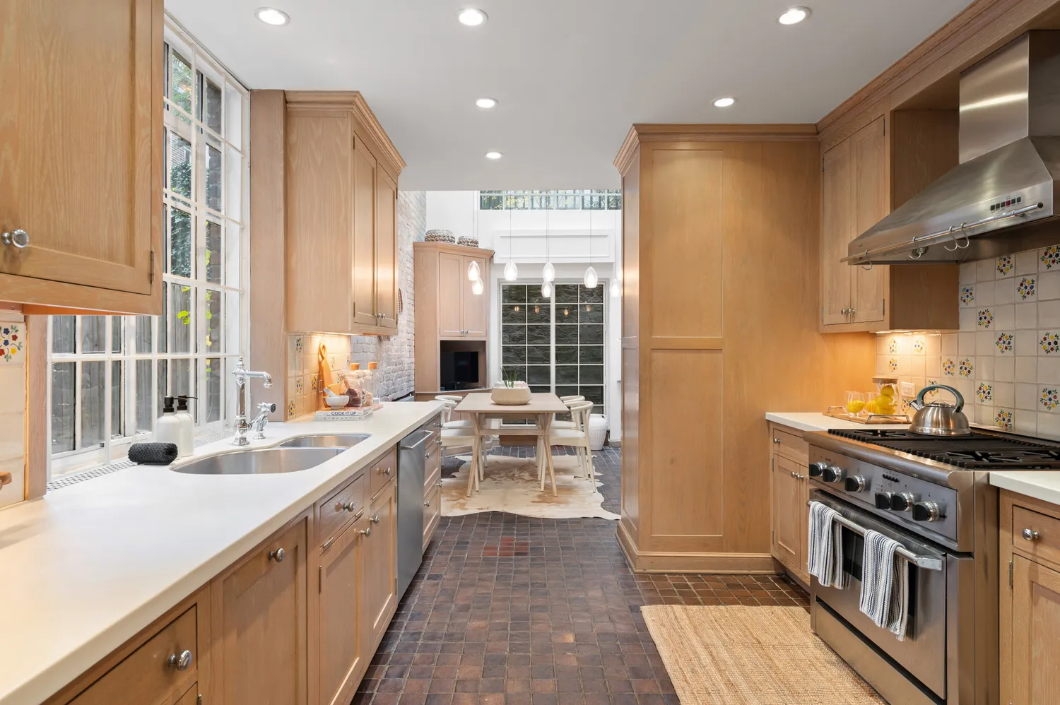 a kitchen with stainless steel appliances a sink stove and cabinets