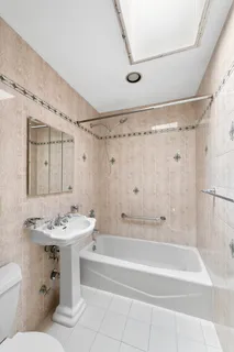 a bathroom with a sink mirror toilet and bathtub