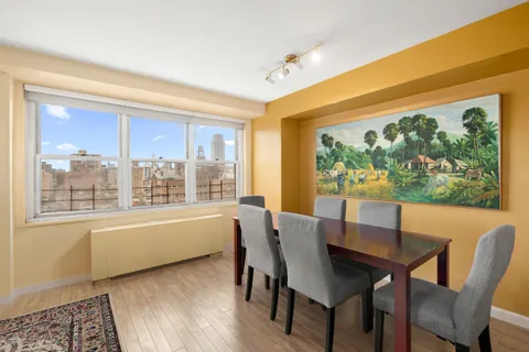 a dining room with furniture and window