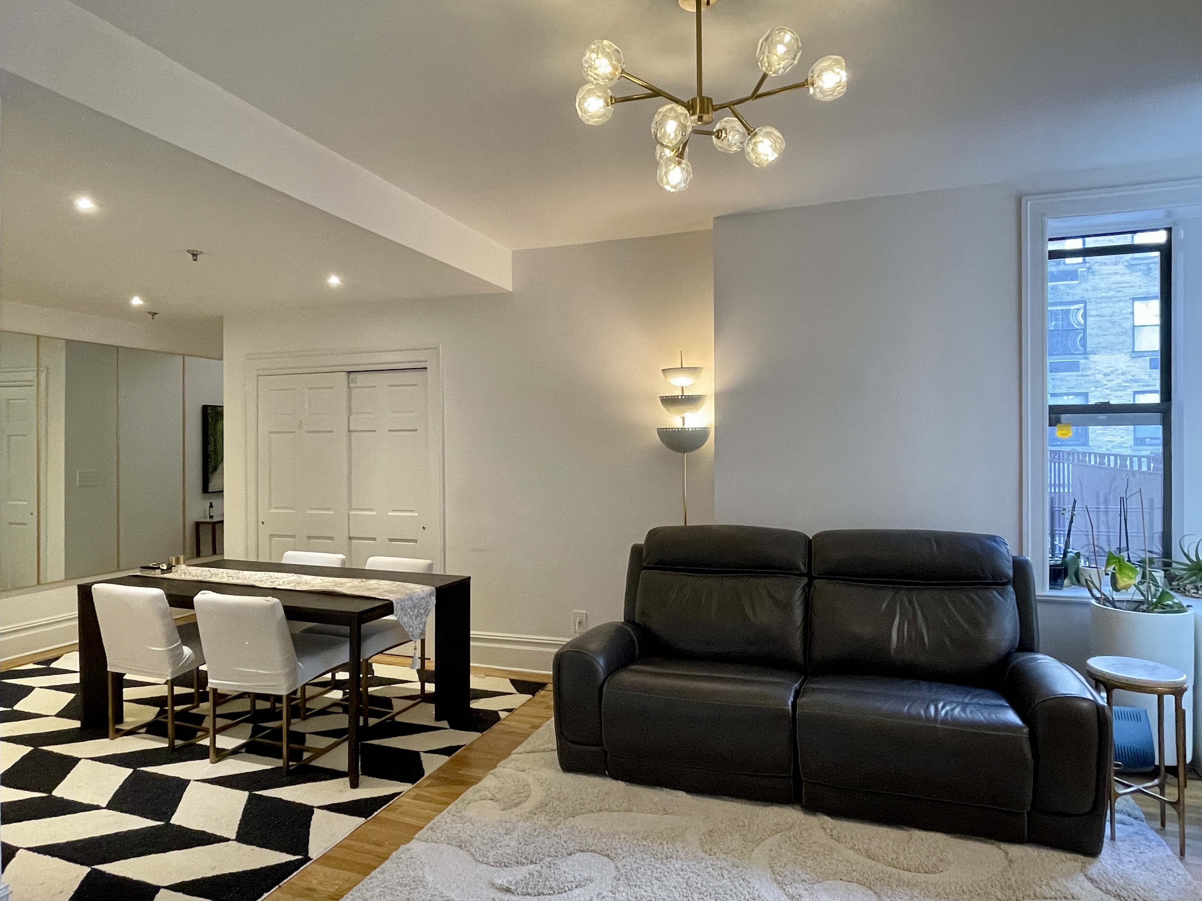 203 West 90th Street, Unit 6B Manhattan, NY 10024 - Photo 8 of 22 a living room with furniture and a chandelier