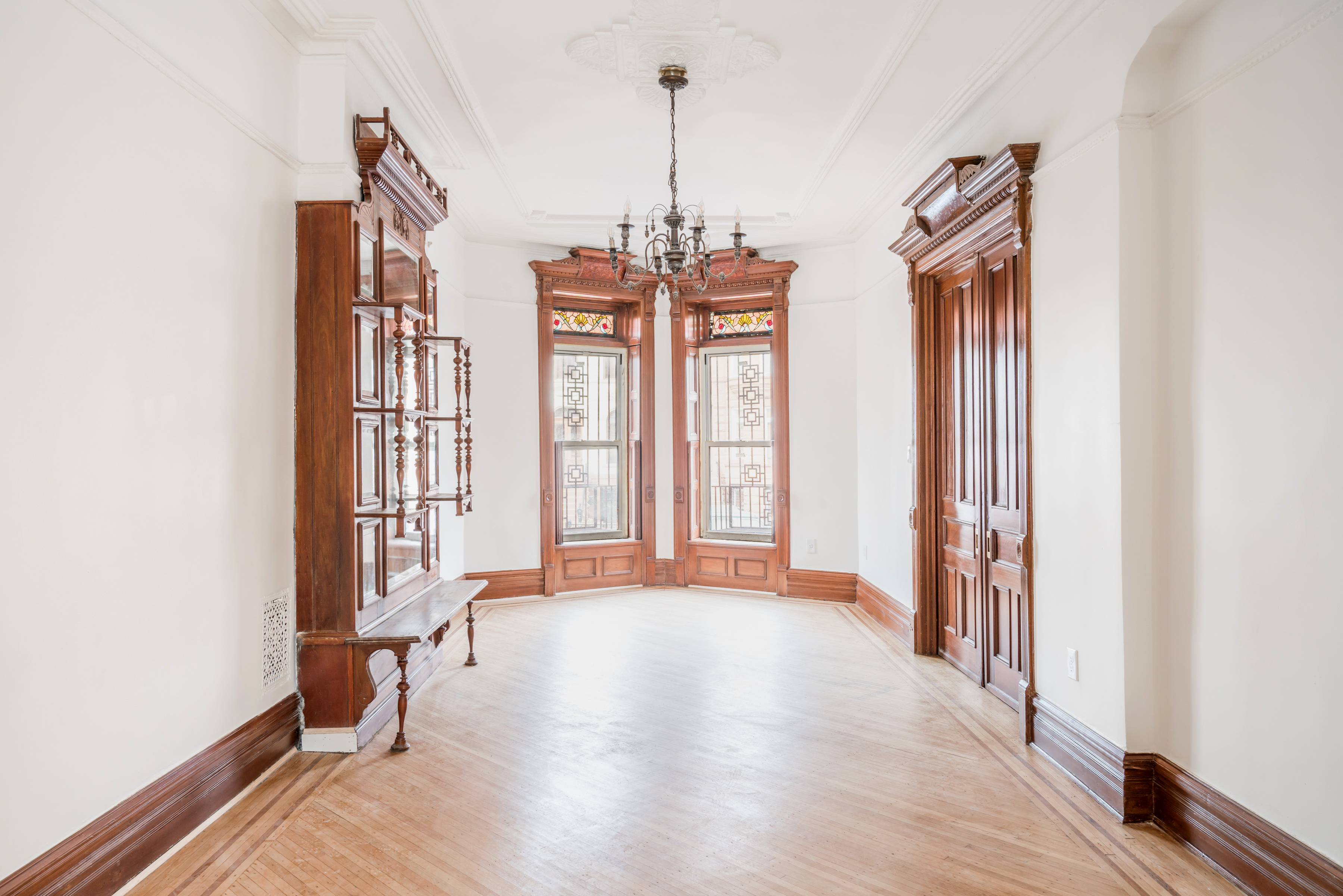 a view of a room with windows and wooden floor