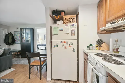 a kitchen with a white stove top oven and refrigerator