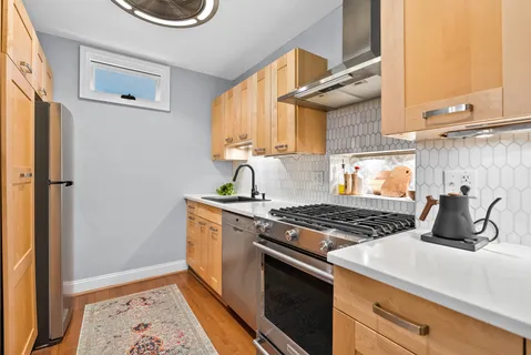 a kitchen with granite countertop a stove and a cabinets