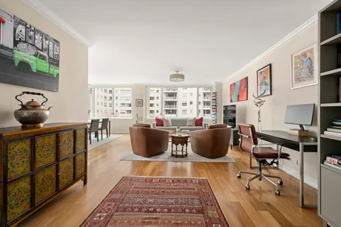 a living room with furniture a rug and a window