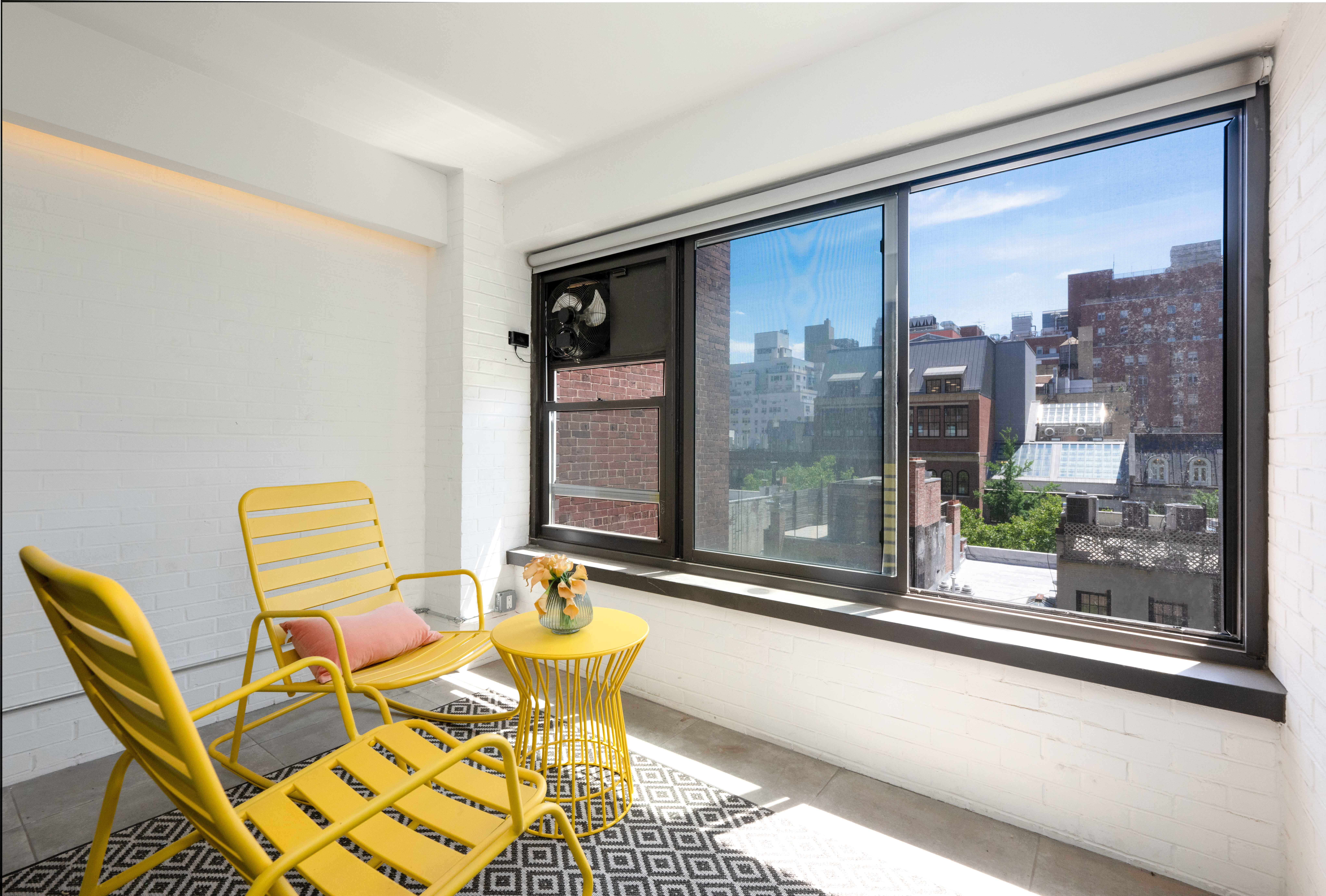 124 East 79th Street, Unit 7D Manhattan, NY 10075 - Photo 17 of 25 a blue chair sitting in front of a window