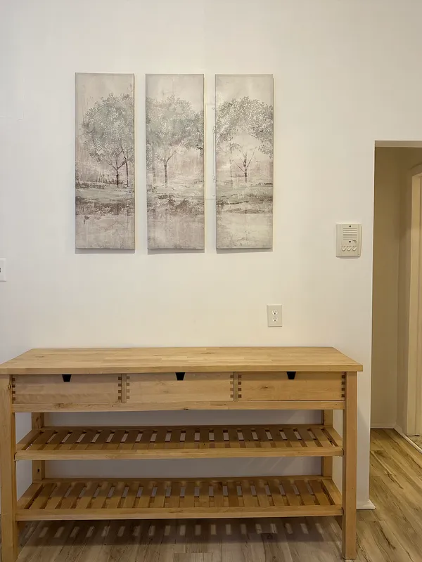 a view of a room with wooden floor and window