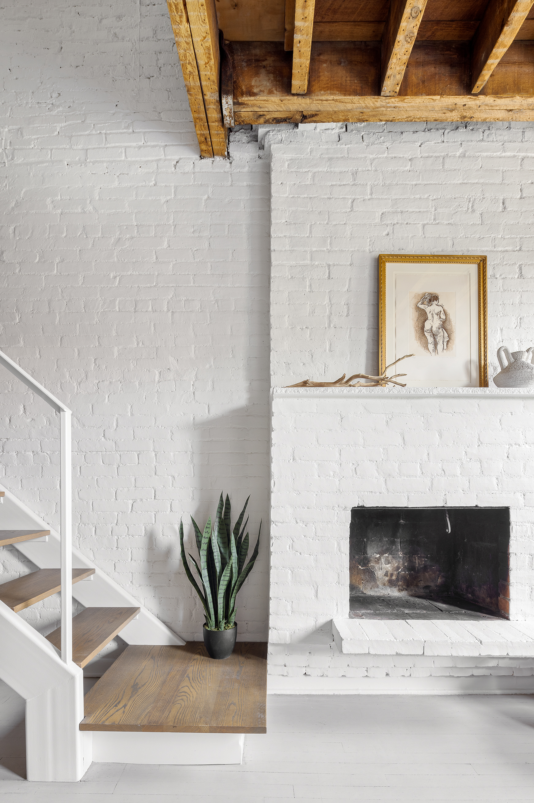 281 West 11th Street, Unit 4/5C Manhattan, NY 10014 - Photo 6 of 18 a white building with a potted plant on the wall