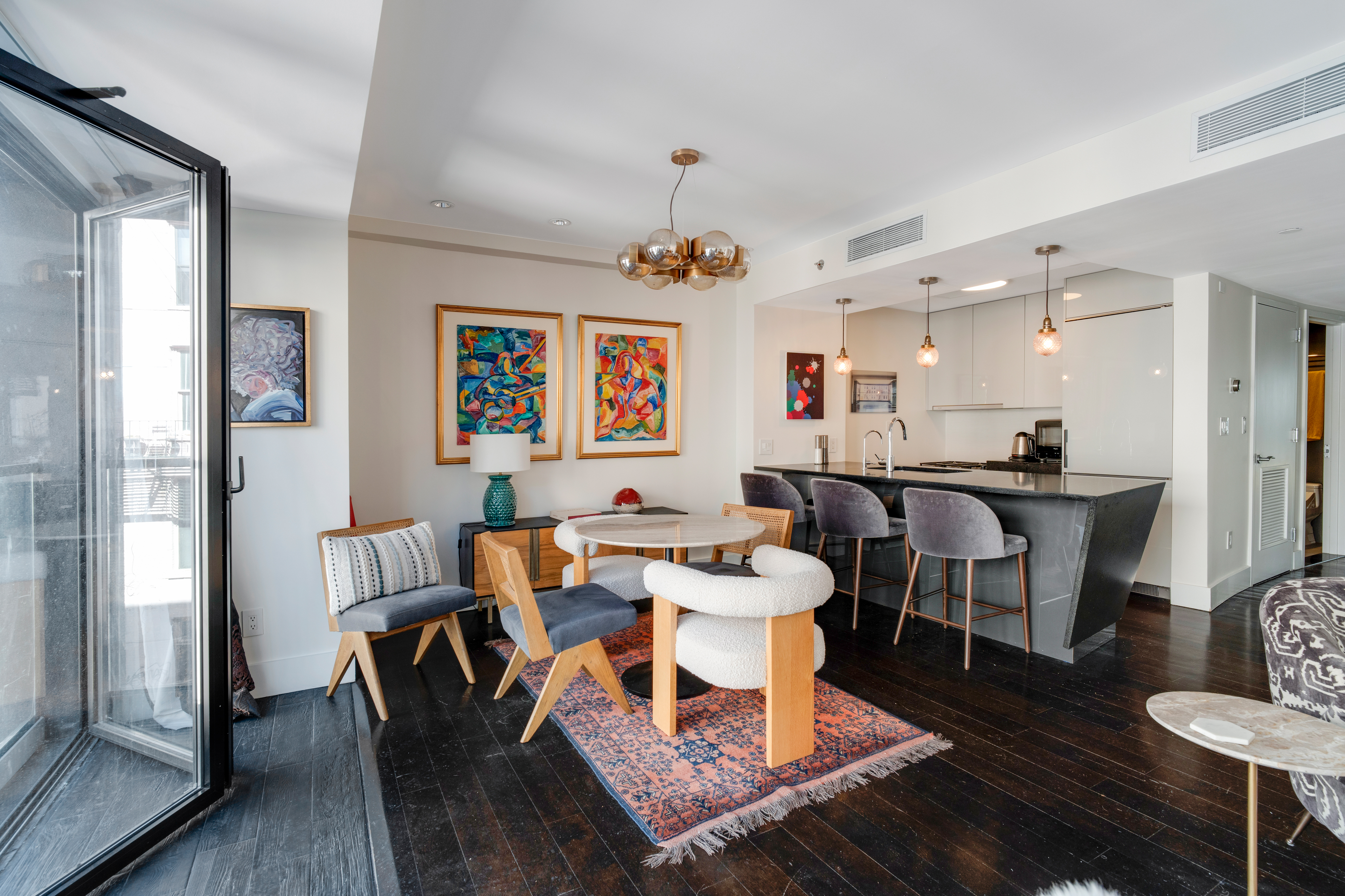 60 Orchard Street, Unit 4 Manhattan, NY 10002 - Photo 10 of 18 a view of a dining room with furniture wooden floor and a chandelier