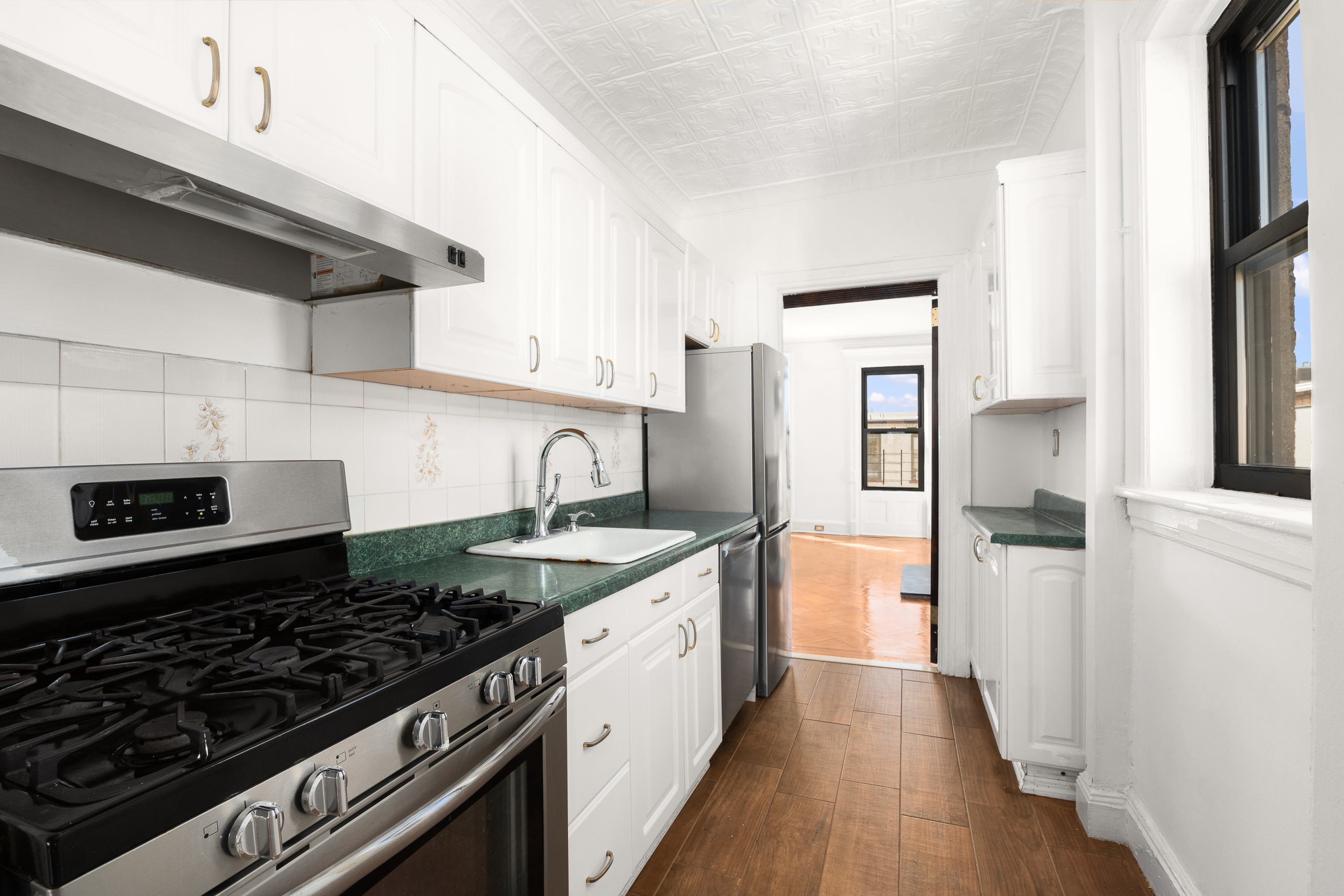 420 8th Street Brooklyn, NY 11215 - Photo 12 of 20 a kitchen with a stove and a refrigerator