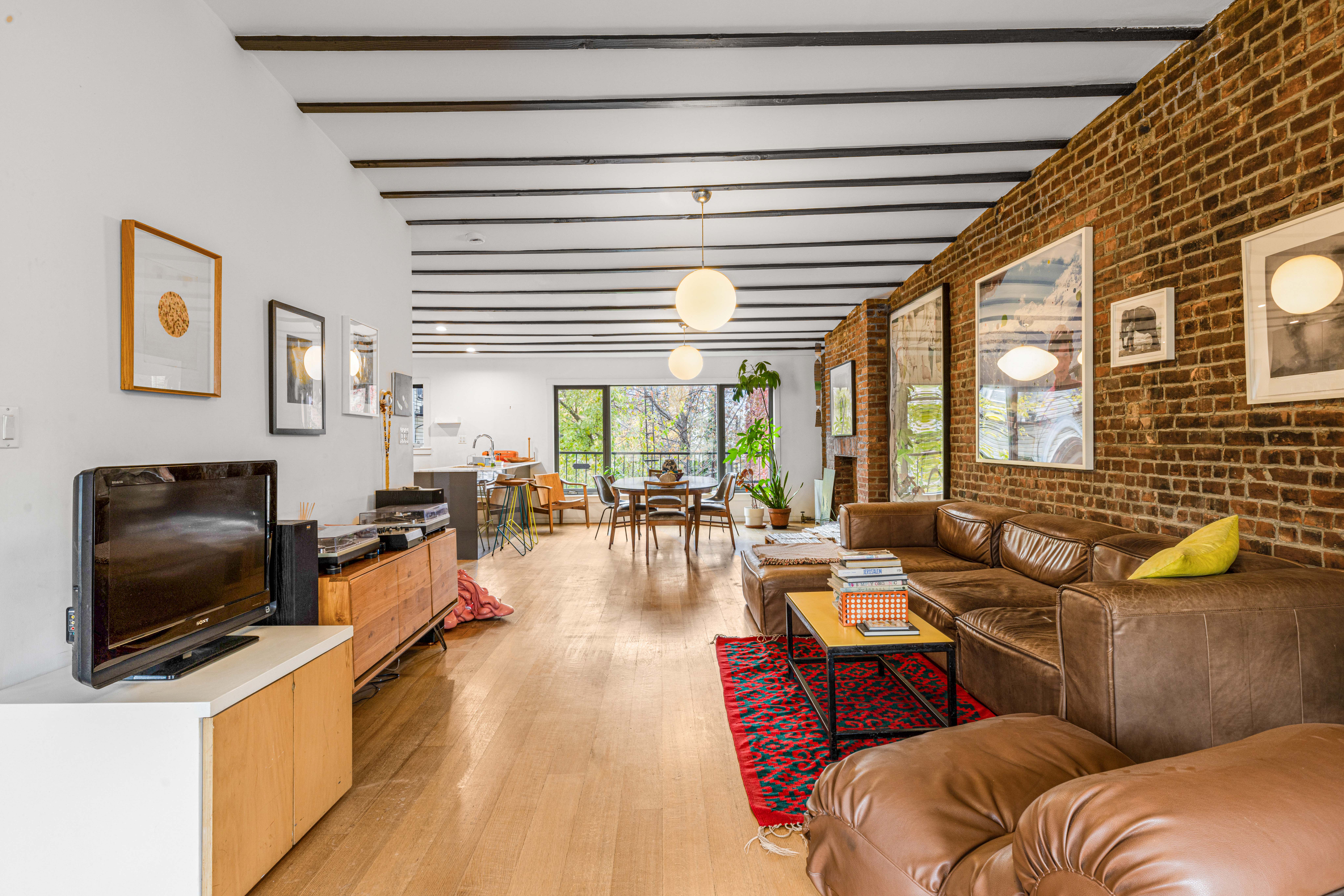 209 Calyer Street, Unit 2 Brooklyn, NY 11222 - Photo 4 of 17 a living room with furniture and a flat screen tv