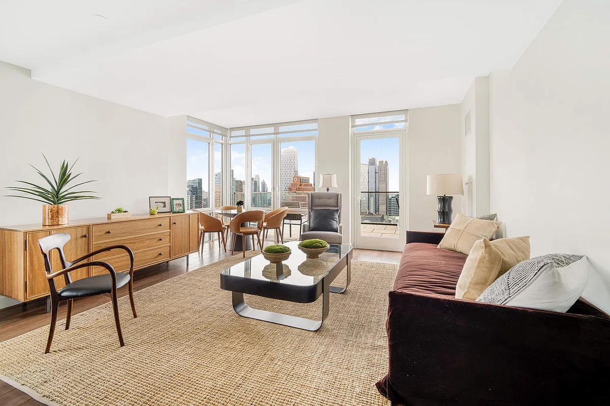 120 Nassau Street, Unit 10J Brooklyn, NY 11201 - Photo 2 of 11 a living room with furniture and a large window