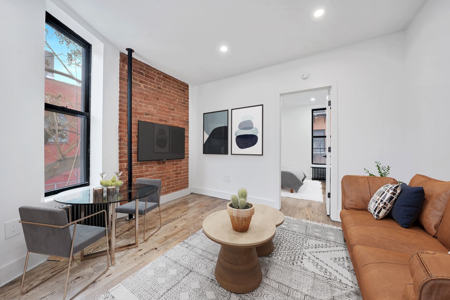 66 West 138th Street, Unit 2C Manhattan, NY 10037 - Photo 1 of 5 a living room with furniture and a large window