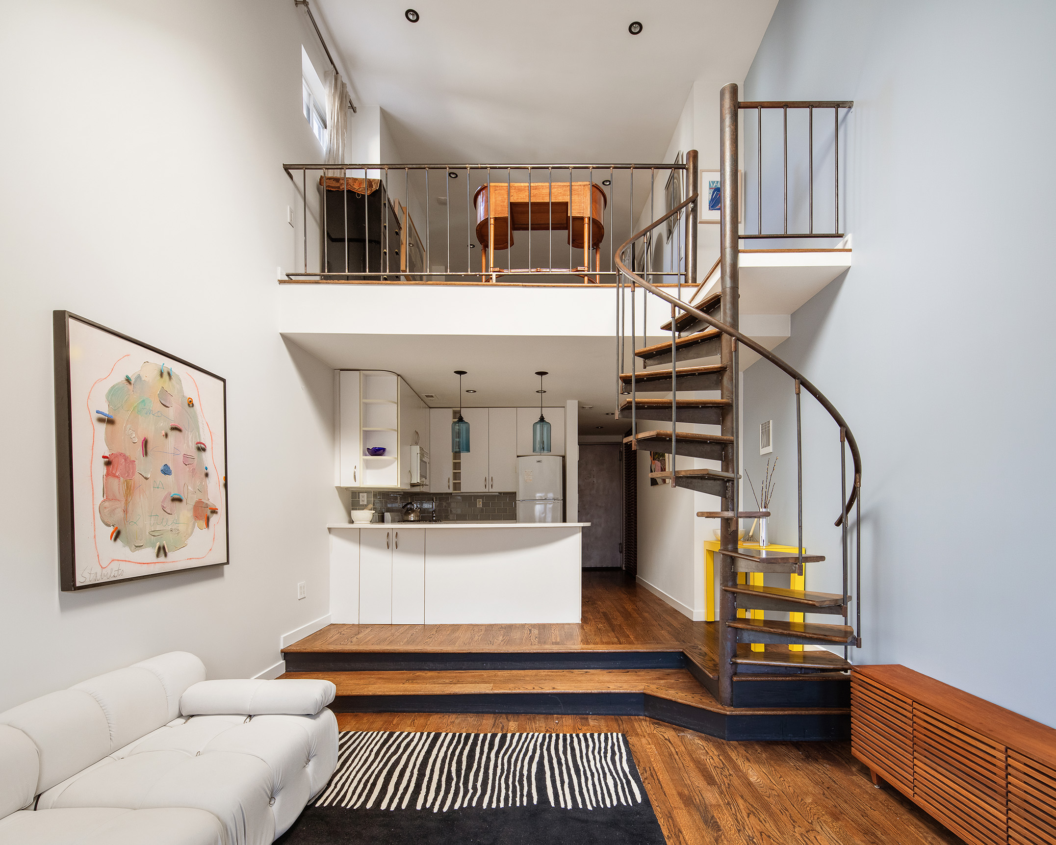 211 Thompson Street, Unit PH6D Manhattan, NY 10012 - Photo 3 of 10 a living room with furniture and a wooden floor