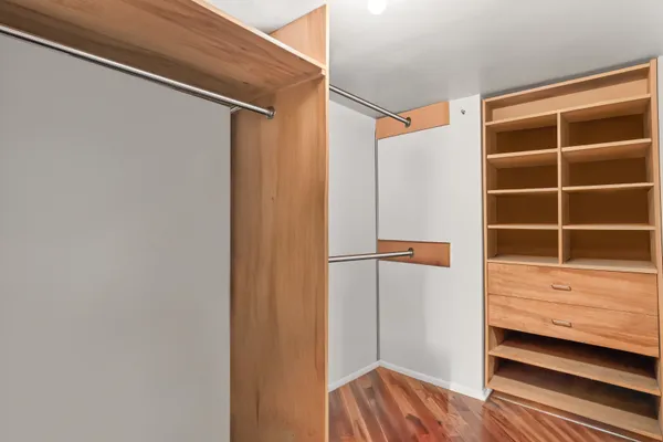 a view of walk in closet with empty racks