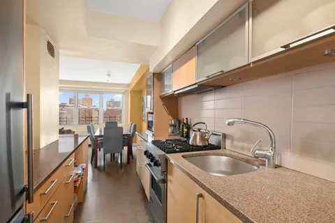 a kitchen with sink a faucet and chairs