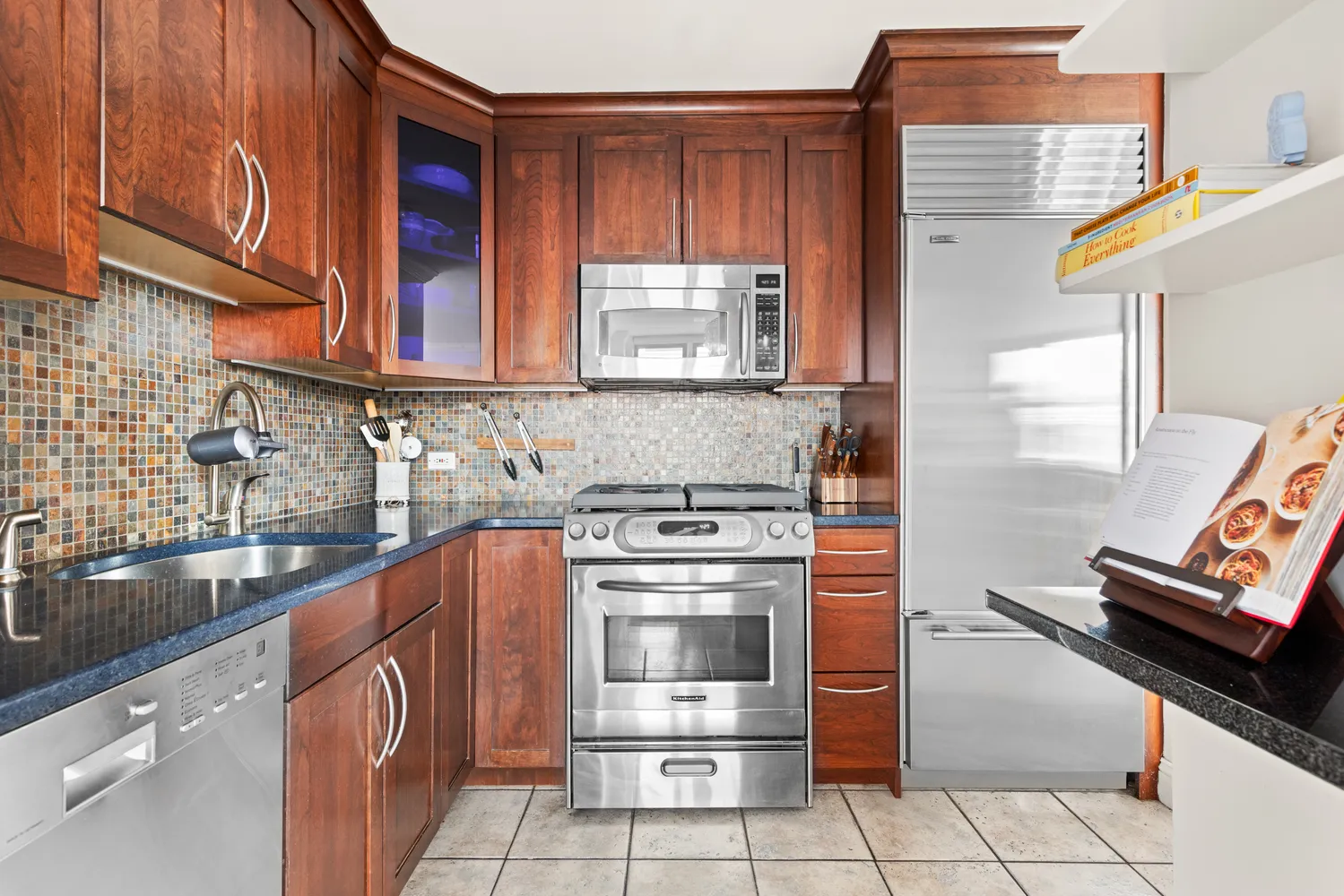 a kitchen with stainless steel appliances granite countertop a stove and a sink