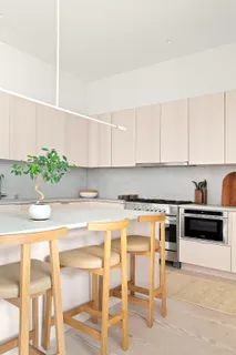 a kitchen with a stove a sink and cabinets