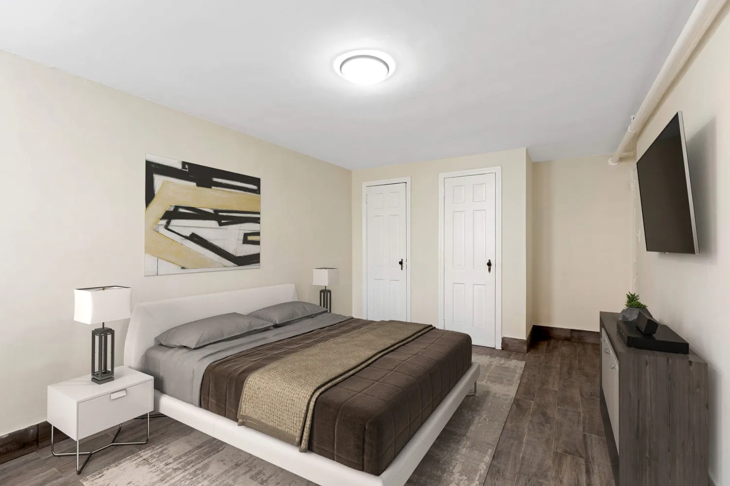 a bedroom with a bed and a flat screen tv