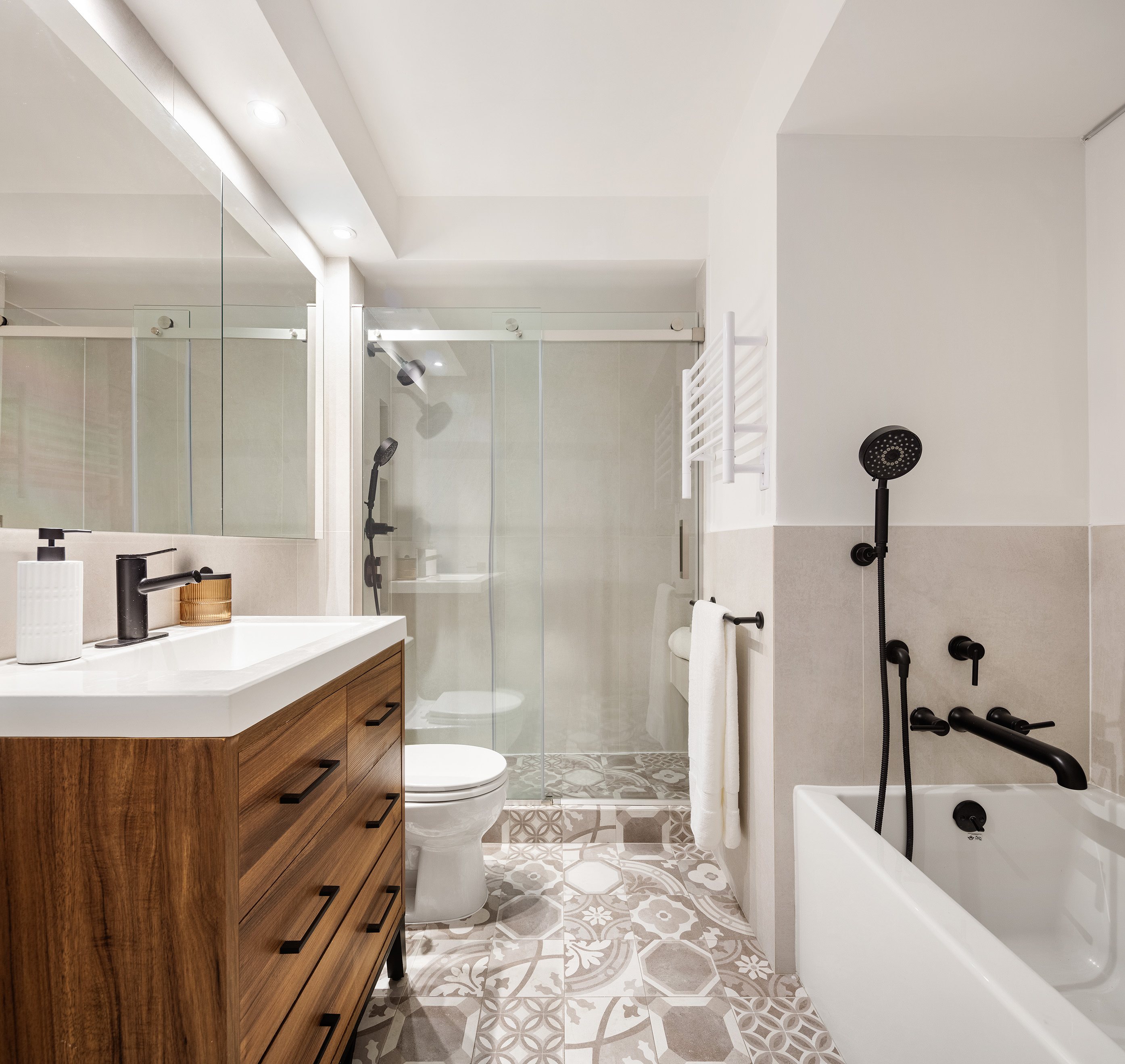 171 East 84th Street, Unit 25B/C Manhattan, NY 10028 - Photo 12 of 13 a bathroom with a sink a toilet a mirror and shower