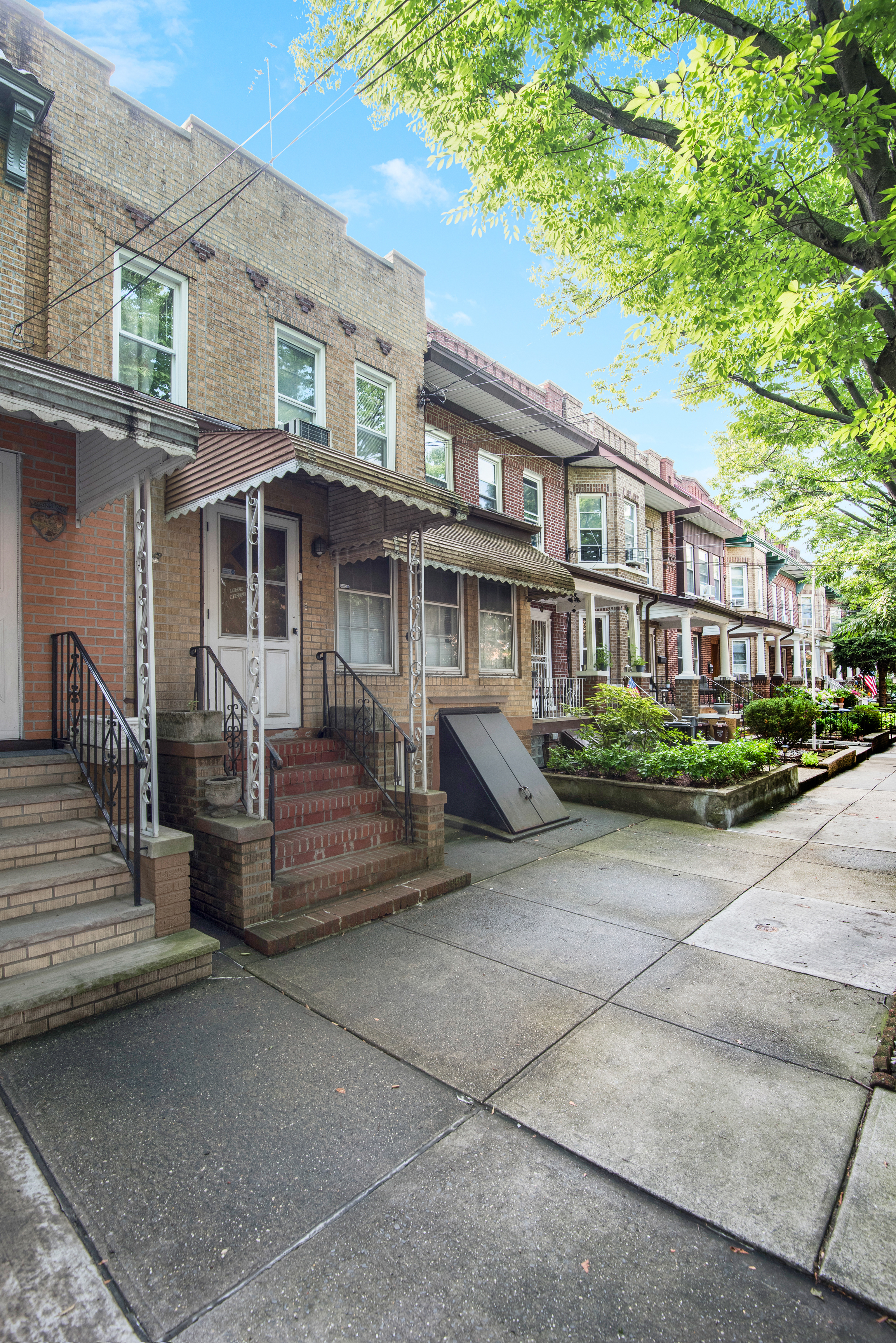 75-36 60th Lane Queens, NY 11385 - Photo 2 of 18 a front view of a house with a porch