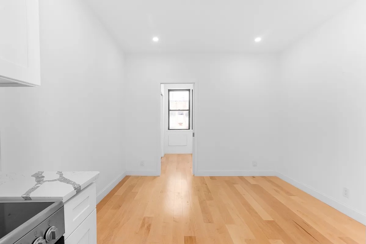 324 East 84th Street, Unit 1D Manhattan, NY 10028 - Photo 2 of 6 a view of a room with wooden floor and cabinet