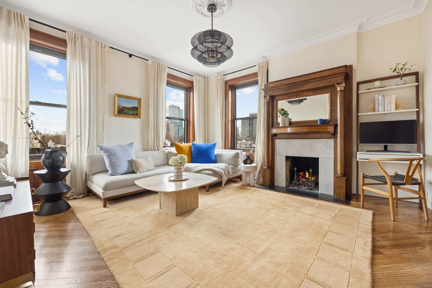 a living room with furniture a fireplace and a flat screen tv