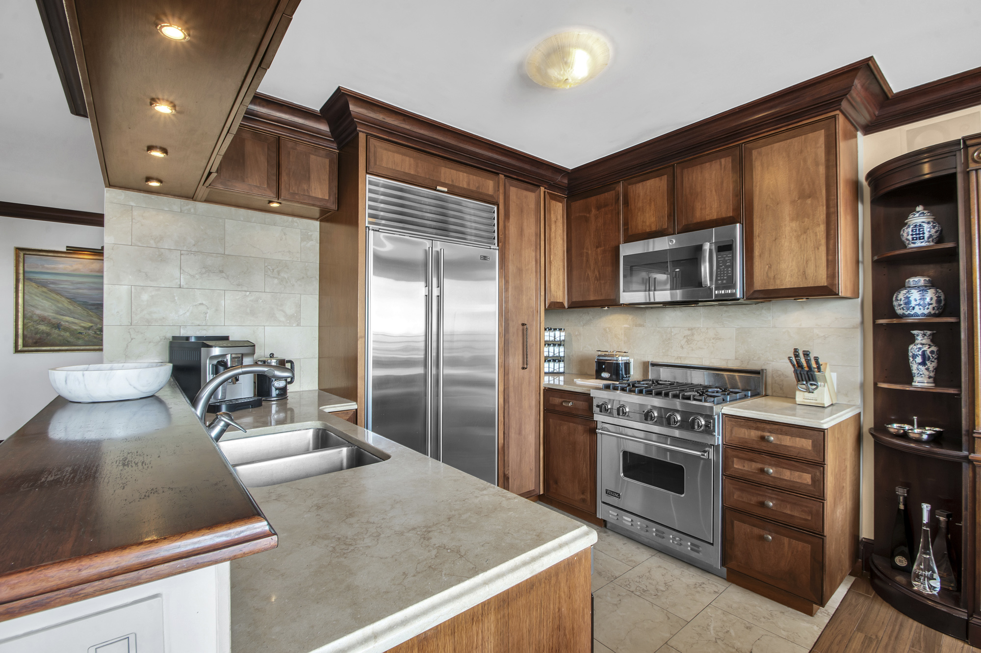 21 South End Avenue, Unit PH1A Manhattan, NY 10280 - Photo 7 of 32 a kitchen with stainless steel appliances granite countertop a sink stove and refrigerator