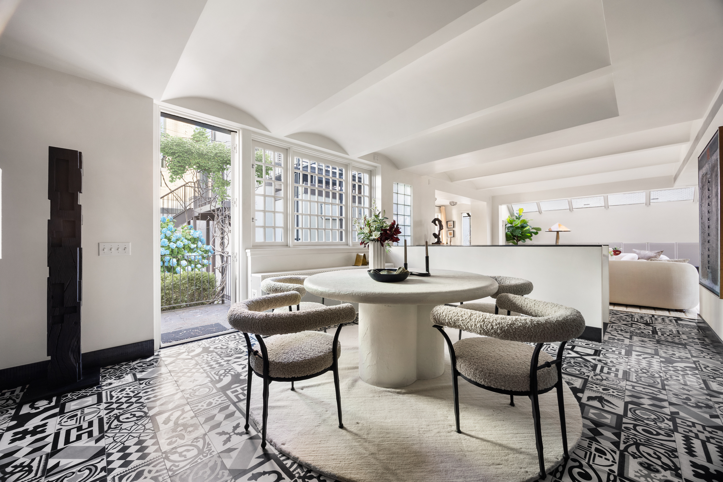15 East 70th Street, Unit PHB Manhattan, NY 10021 - Photo 11 of 35 a kitchen with a dining table chairs and large windows