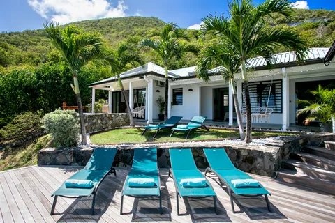 a view of a house with pool and chairs