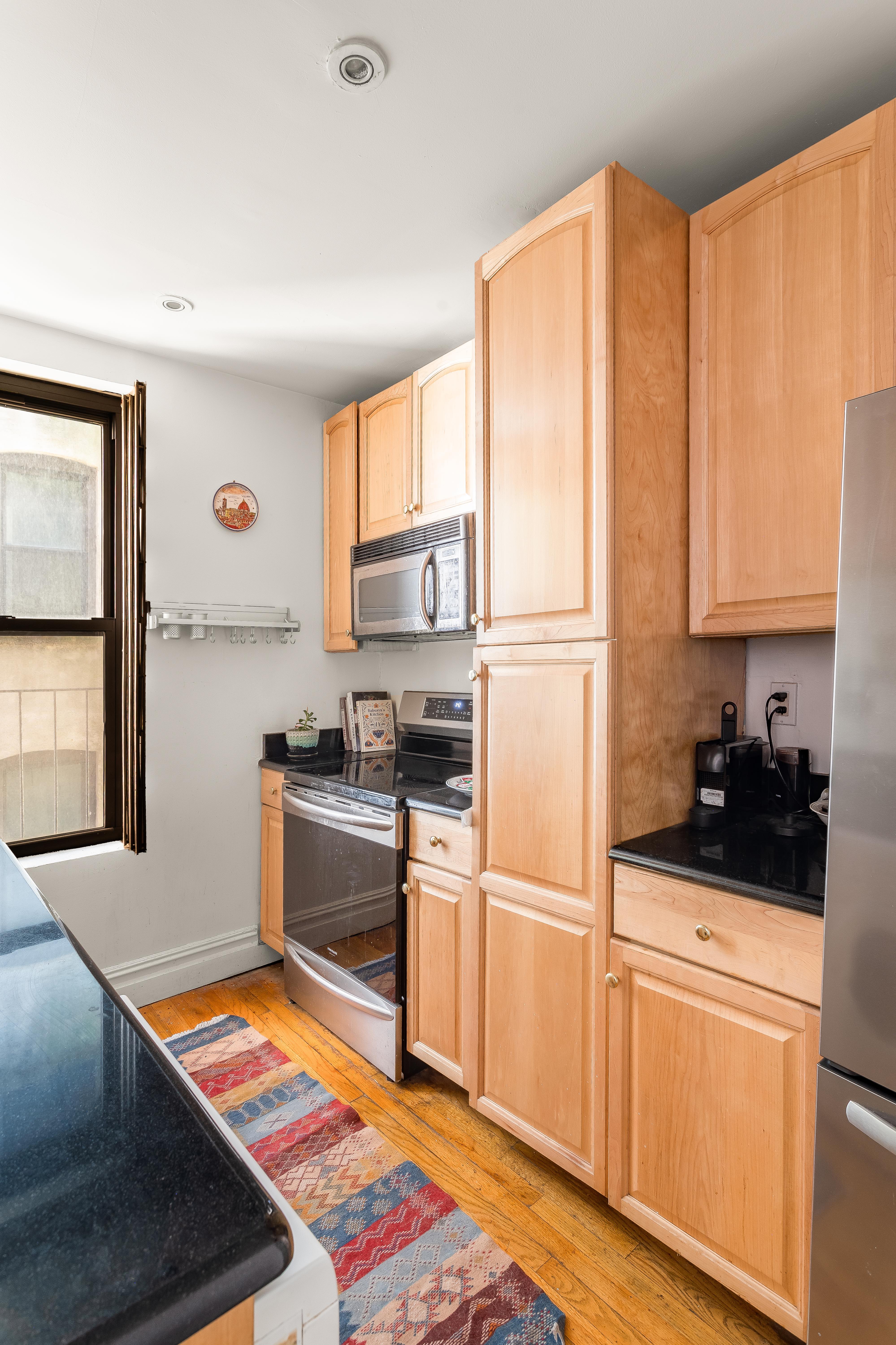 501 West 122nd Street, Unit A2 Manhattan, NY 10027 - Photo 6 of 21 a kitchen with a sink appliances and cabinets