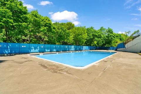 a view of a swimming pool with an outdoor space and seating area