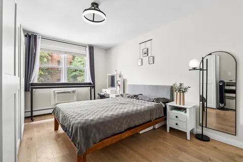 a bedroom with a bed and a window