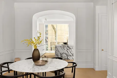 a dining room with furniture and wooden floor