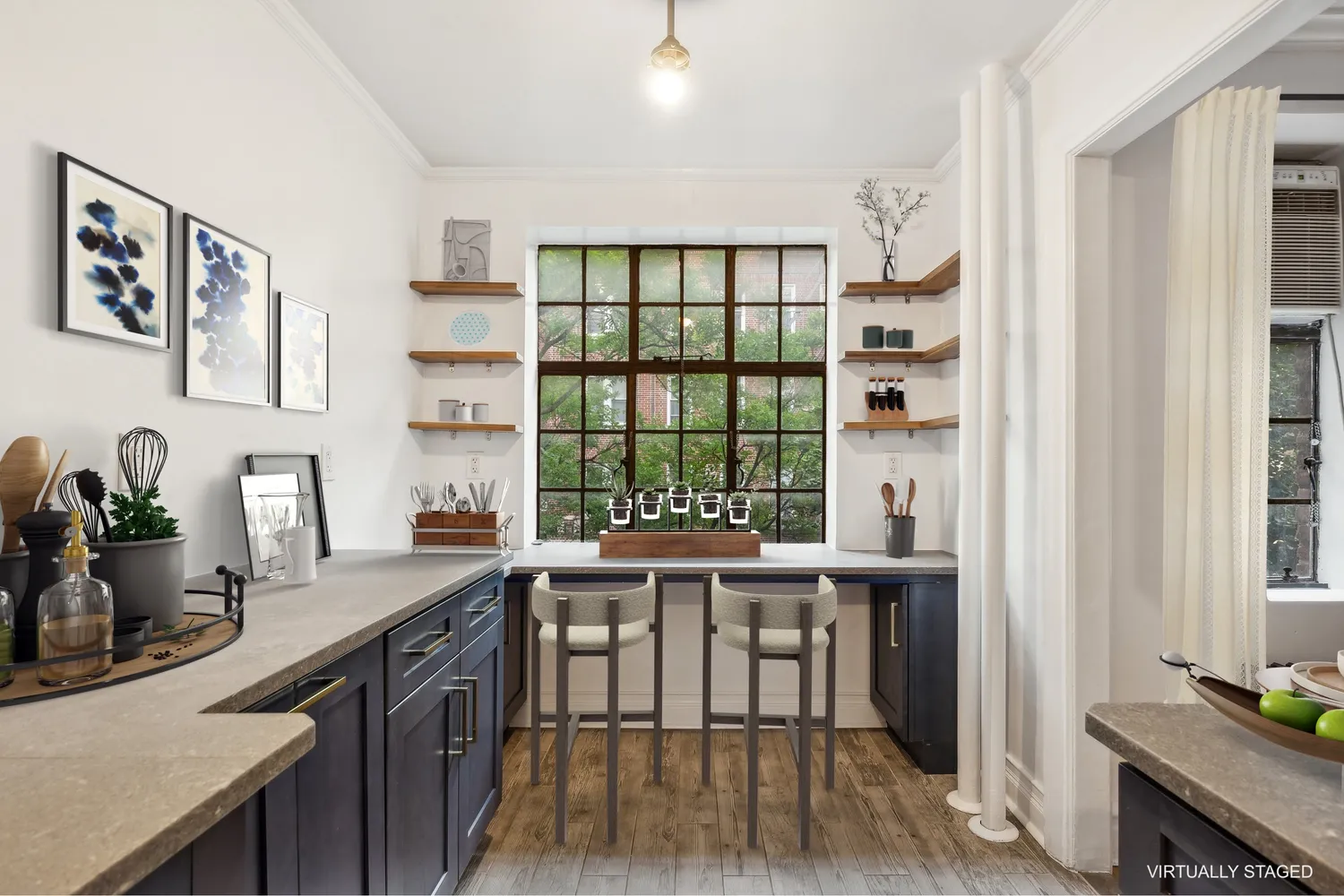 a view of a kitchen filled with furniture and wooden floor