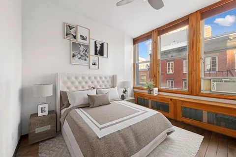 a bedroom with a large bed and a large window