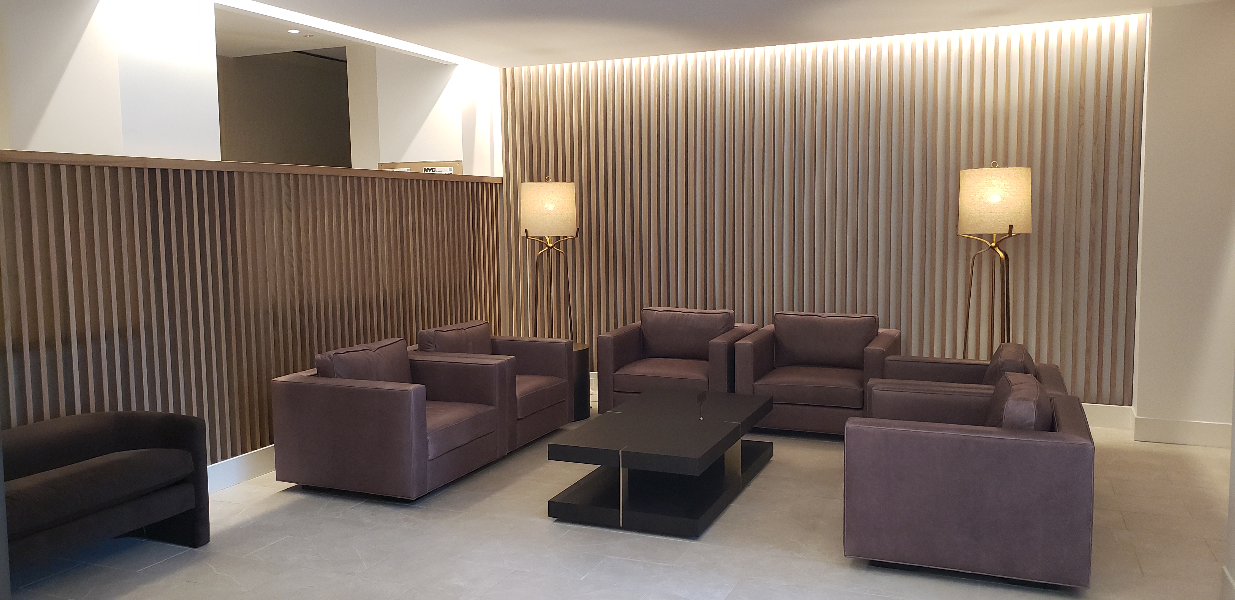 70-25 Yellowstone Boulevard, Unit 11D Queens, NY 11375 - Photo 17 of 25 a living room with furniture and a potted plant