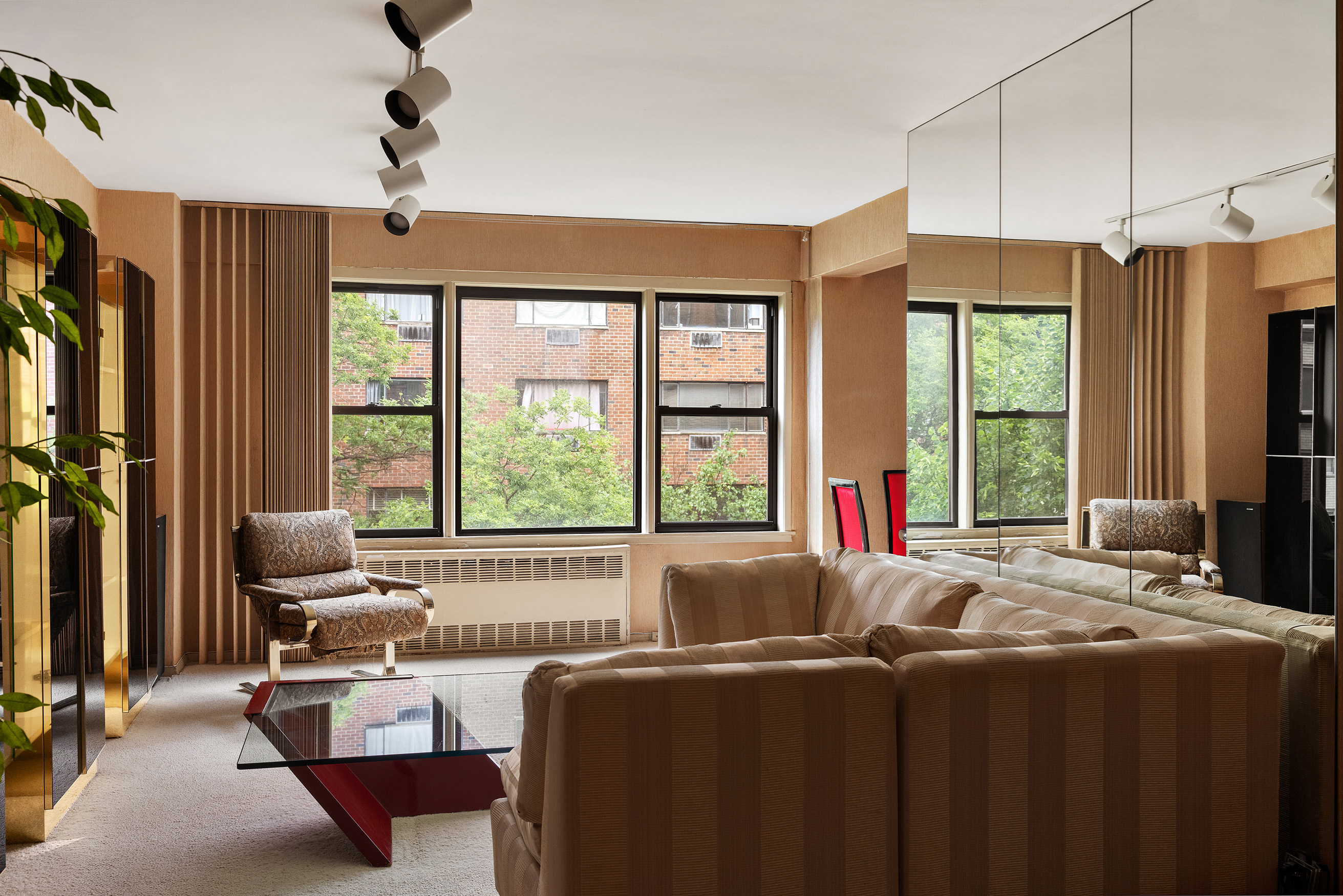 515 East 85th Street, Unit 6D Manhattan, NY 10028 - Photo 2 of 16 a living room with furniture and large windows