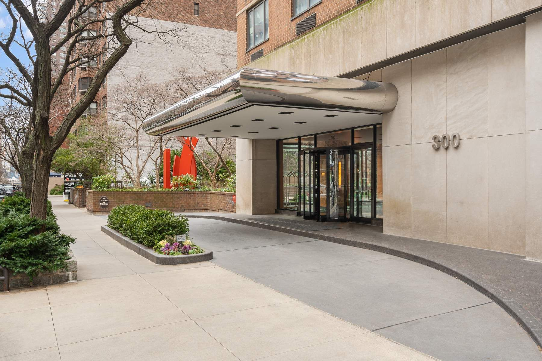 300 East 54th Street, Unit 23J Manhattan, NY 10022 - Photo 16 of 18 a view of a building with a yard and a garden