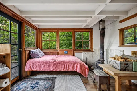 a bed sitting in a bedroom next to a window
