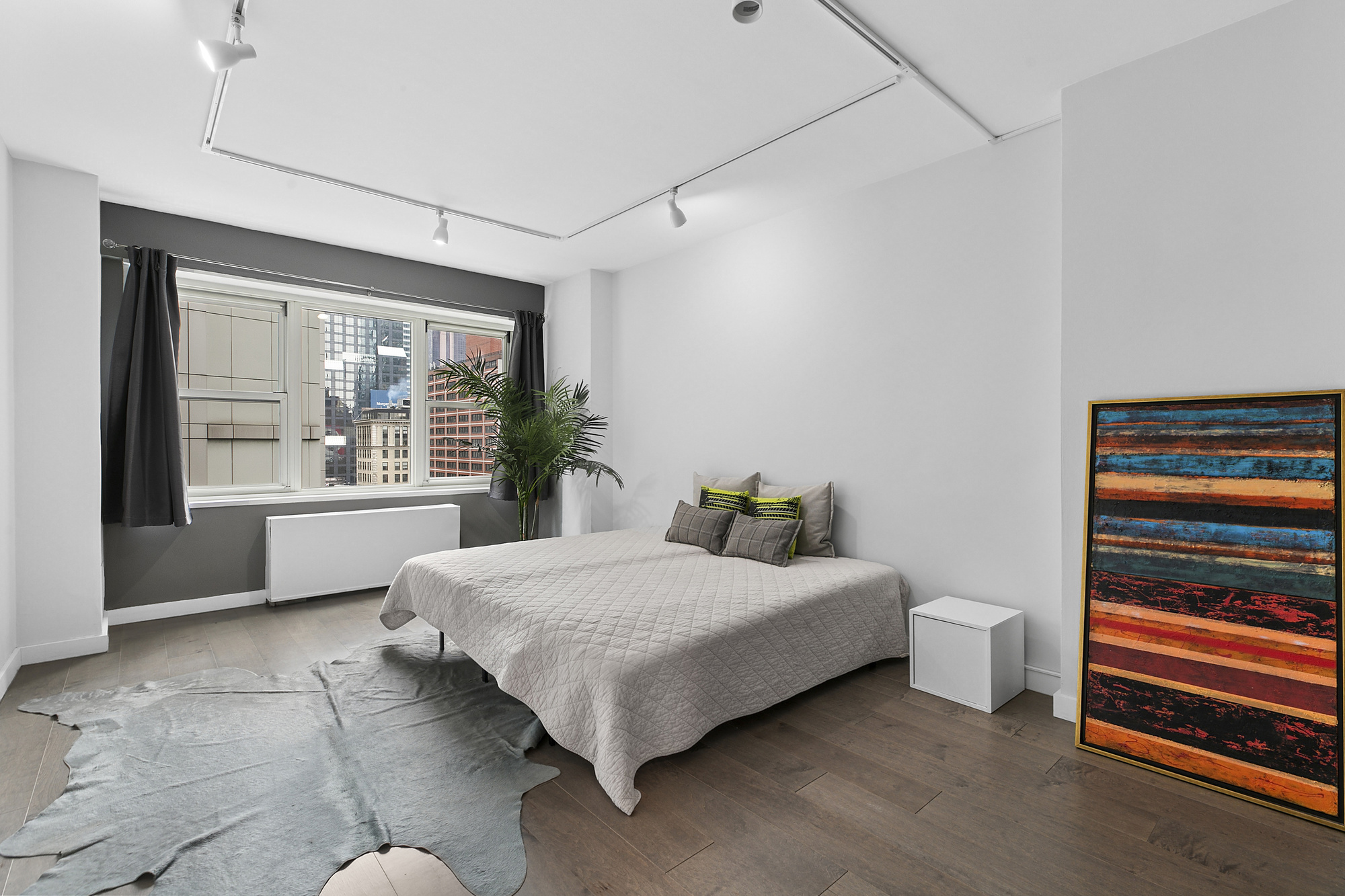 159 West 53rd Street, Unit 11D Manhattan, NY 10019 - Photo 2 of 9 a bedroom with a bed and a window