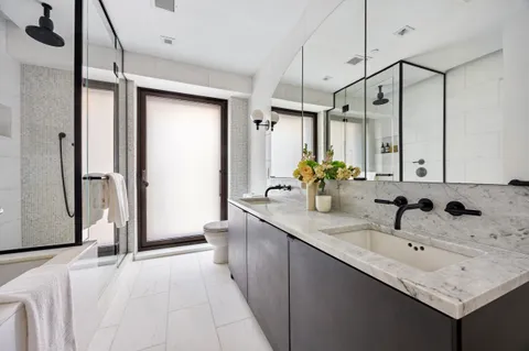 a bathroom with a sink toilet and shower