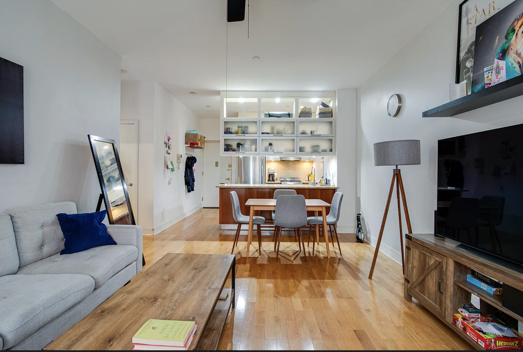 41-26 27th Street, Unit 4B Queens, NY 11101 - Photo 1 of 10 a living room with furniture and a flat screen tv