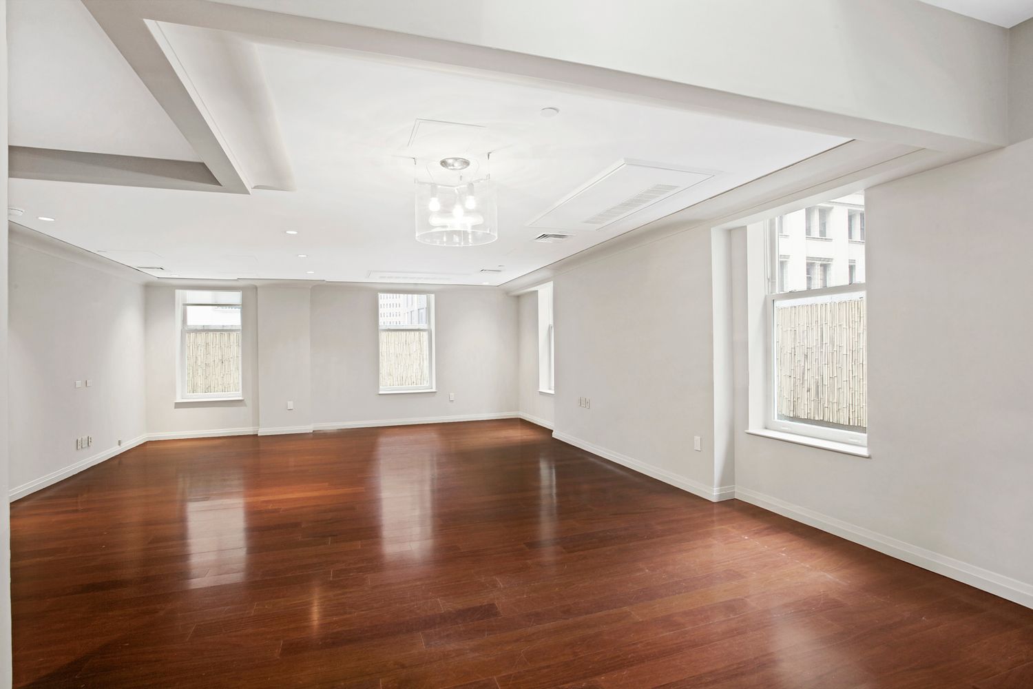 55 Wall Street, Unit PH910 Manhattan, NY 10005 - Photo 2 of 11 an empty room with wooden floor and windows
