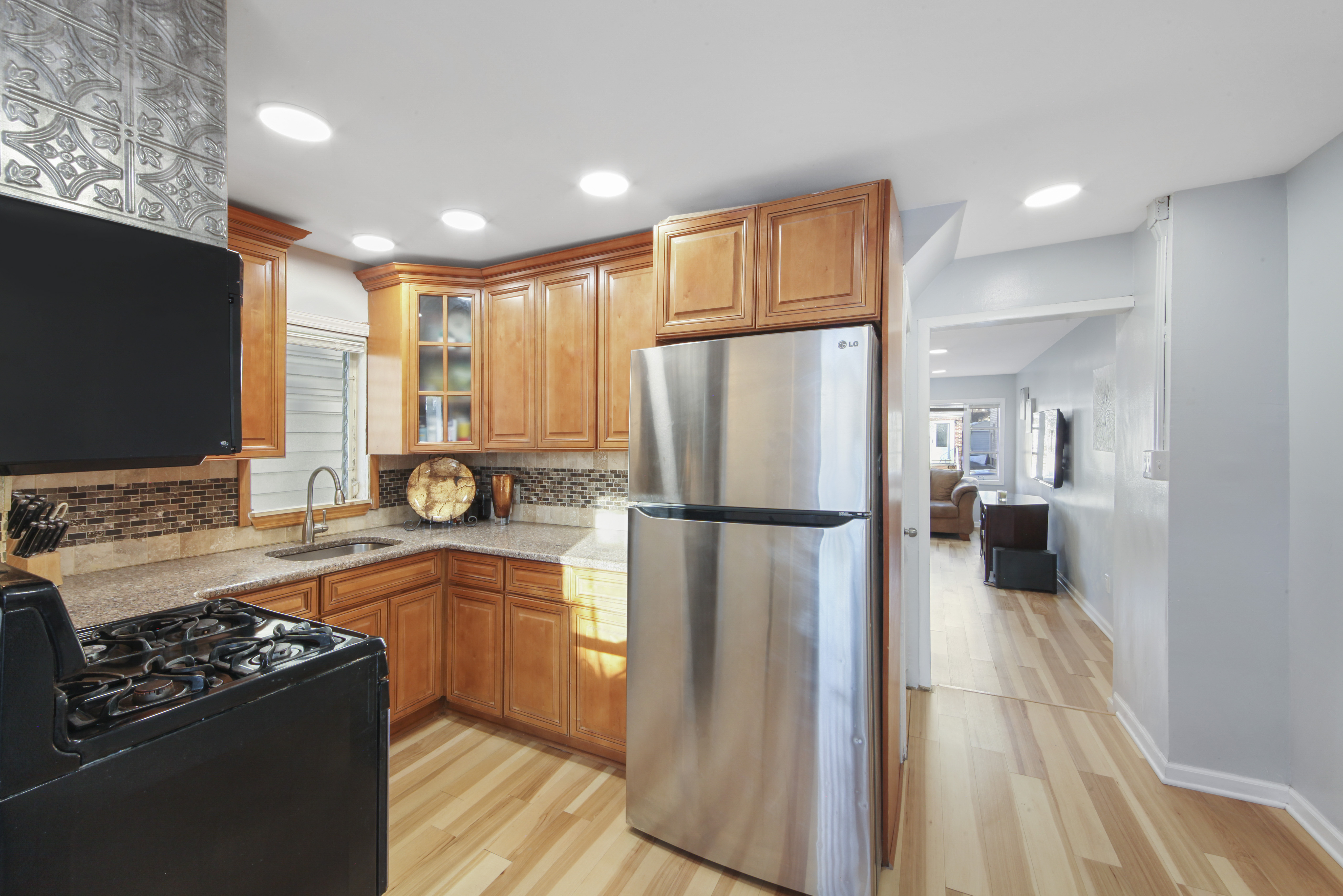 1530 East 51st Street Brooklyn, NY 11234 - Photo 3 of 14 a kitchen with a refrigerator a sink and a stove top oven